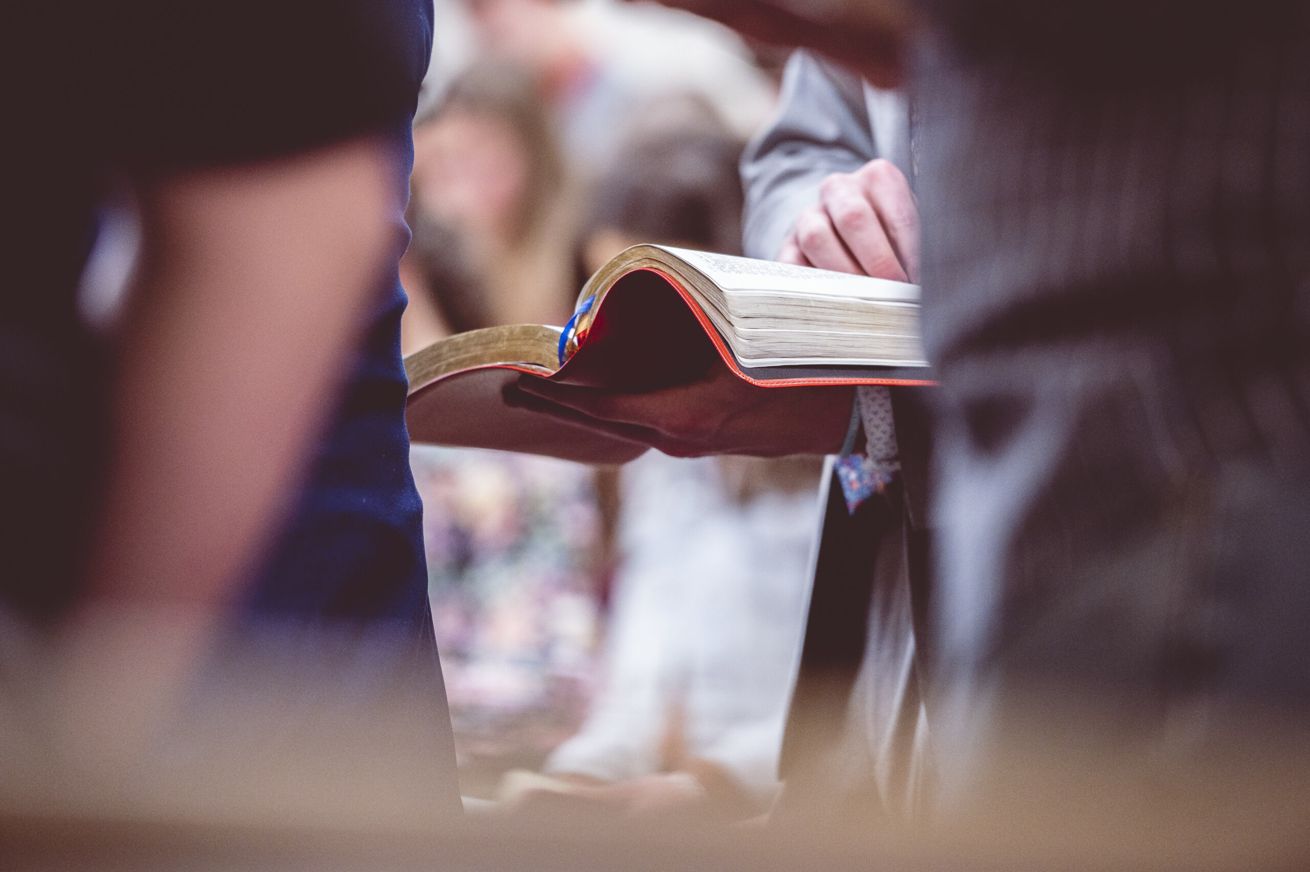 Closeup shot of a book on the man’s hands